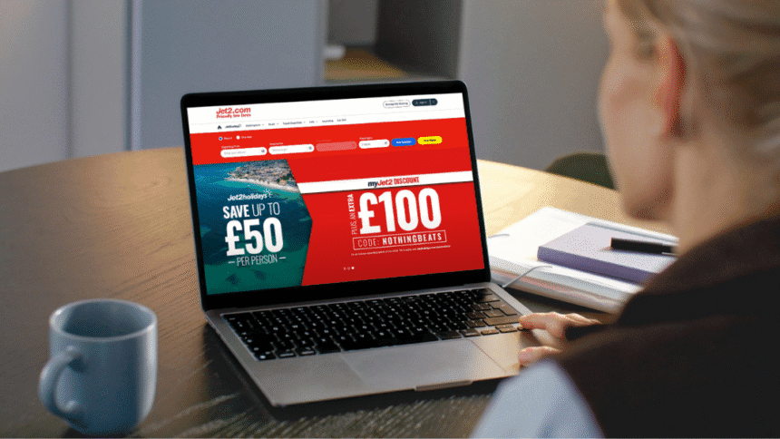Person looking at laptop displaying Jet2 website with holiday deals, relating to how to Book Jet2 Holidays Direct or With a Travel Agent.