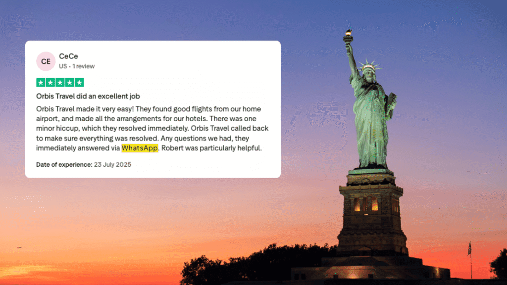 The Statue of Liberty at dusk with a positive customer review praising Orbis Travels for excellent service and helpful communication via WhatsApp.