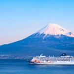 Cruise ship sailing with Mount Fuji in the background, highlighting unique cruise destinations in Japan.