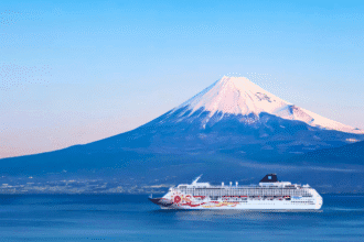 Cruise ship sailing with Mount Fuji in the background, highlighting unique cruise destinations in Japan.